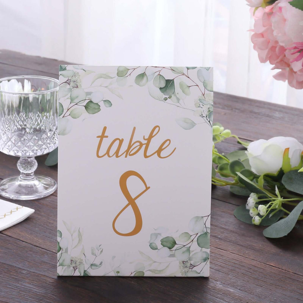 25 - Pack Paper Wedding Table Numbers 1 - 25 White/Green Eucalyptus Leaves Design - Free Standing Double Sided Table Signs with Glam Gold Foil Numbers 7" - Bell Racket Store