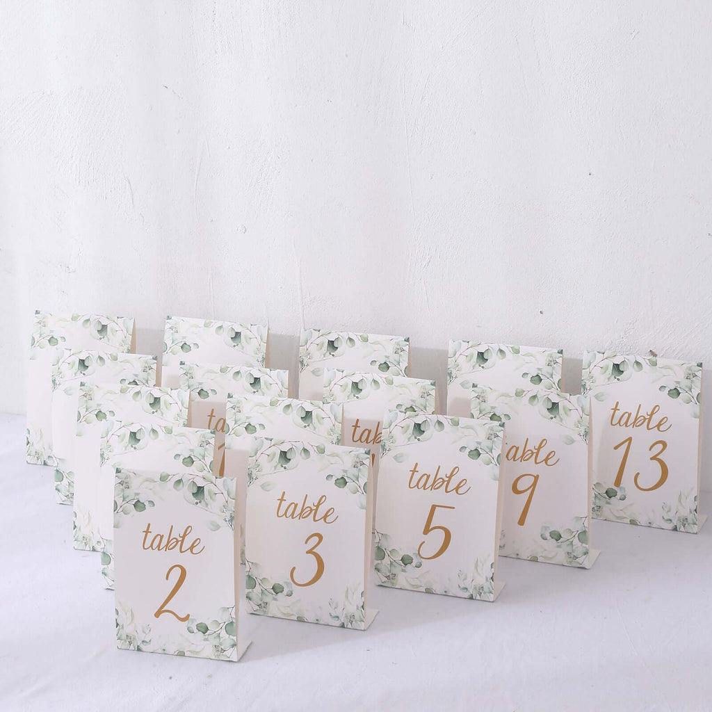 25 - Pack Paper Wedding Table Numbers 1 - 25 White/Green Eucalyptus Leaves Design - Free Standing Double Sided Table Signs with Glam Gold Foil Numbers 7" - Bell Racket Store