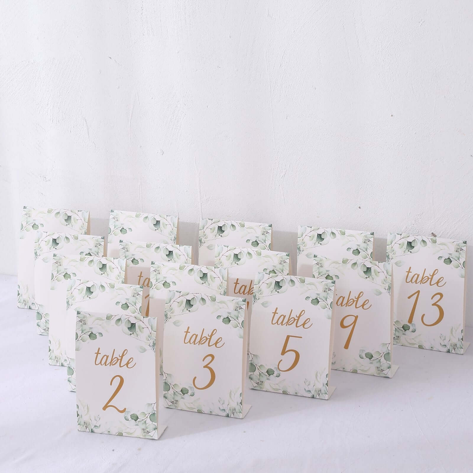 25 - Pack Paper Wedding Table Numbers 1 - 25 White/Green Eucalyptus Leaves Design - Free Standing Double Sided Table Signs with Glam Gold Foil Numbers 7" - Bell Racket Store