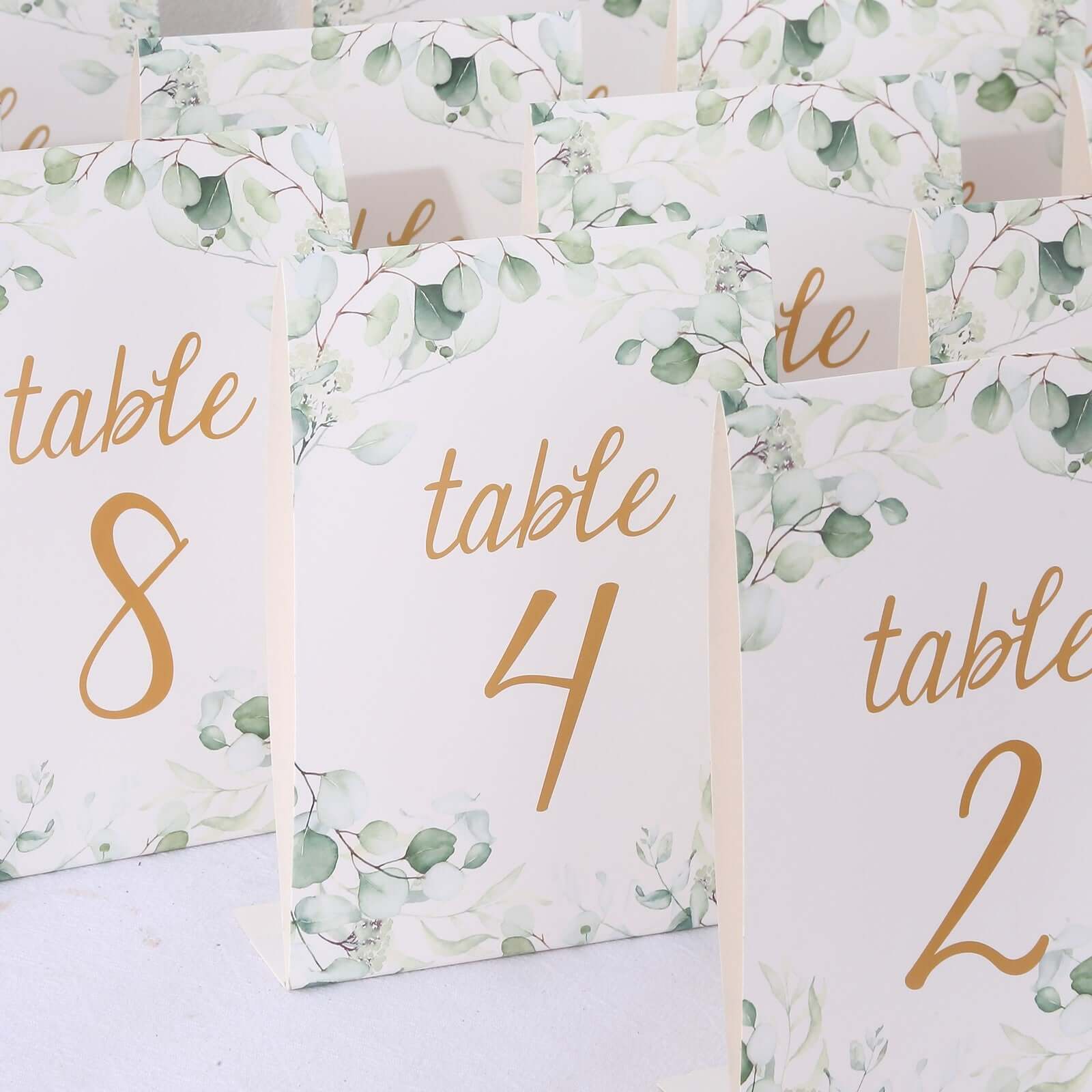 25 - Pack Paper Wedding Table Numbers 1 - 25 White/Green Eucalyptus Leaves Design - Free Standing Double Sided Table Signs with Glam Gold Foil Numbers 7" - Bell Racket Store