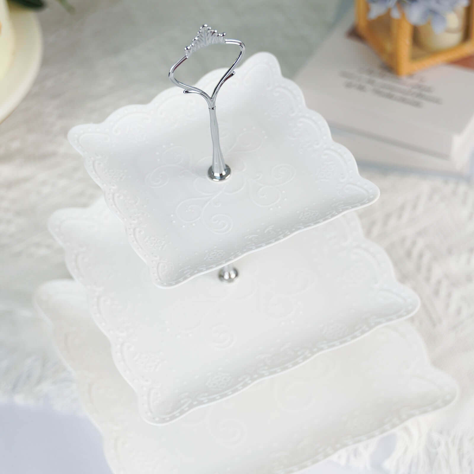3-Tier Plastic Square Cupcake Stand Tower White - Charming Easy to Assemble Dessert Display Serving Tray Platter with Floral Embossed Scalloped Rim & Silver Handle for Tea Parties Weddings & Special Occasions 13"
